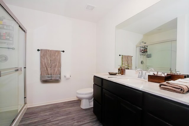 8506 Stillwater Rd, Wonder Lake, IL 60097 - bathroom with a shower stall, wood finished floors, vanity, toilet, and baseboards