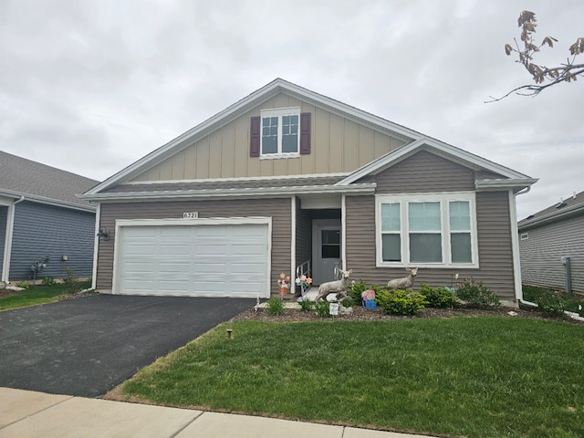 6321 Aspen Ln, Wonder Lake, IL 60097 - view of front of home with board and batten siding, asphalt driveway, a front lawn, and a garage