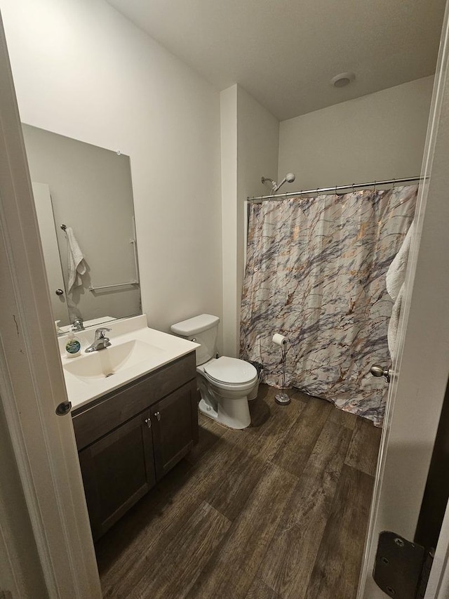 6321 Aspen Ln, Wonder Lake, IL 60097 - bathroom with wood finished floors, toilet, vanity, and a shower with curtain