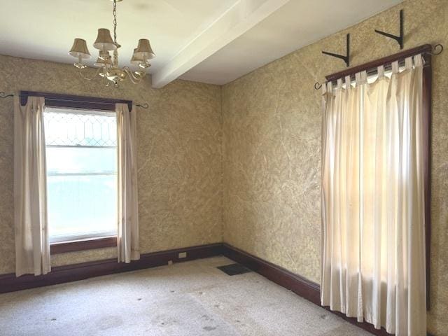 903 S Division Ave, Polo, IL 61064 - unfurnished room with a chandelier, beam ceiling, and carpet