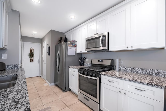 5239 Diamond Dr Unit B, Oak Forest, IL 60452 - kitchen with stainless steel appliances, white cabinets, stone countertops, light tile patterned floors, and baseboards