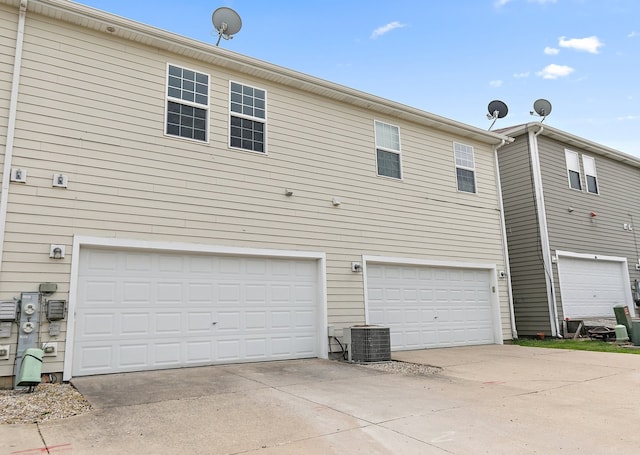 101 E Robinson Ave, Cortland, IL 60112 - back of property featuring central AC, an attached garage, and driveway