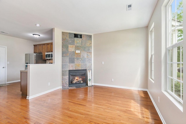 101 E Robinson Ave, Cortland, IL 60112 - unfurnished living room featuring light wood finished floors, healthy amount of natural light, and baseboards