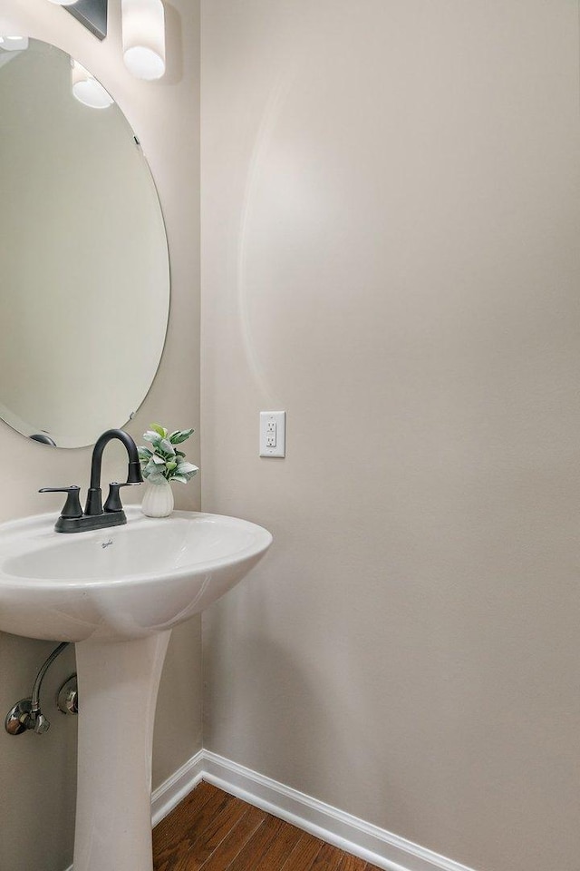 101 E Robinson Ave, Cortland, IL 60112 - bathroom with wood finished floors, baseboards, and a sink