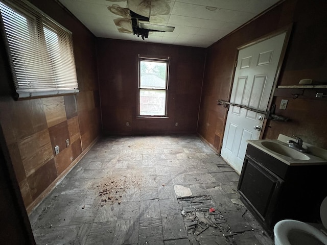 unfurnished dining area featuring a sink and baseboards