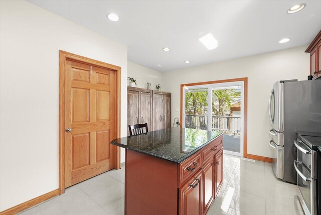 7050 26th Pkwy, Berwyn, IL 60402 - kitchen with appliances with stainless steel finishes, dark stone counters, baseboards, a center island, and recessed lighting
