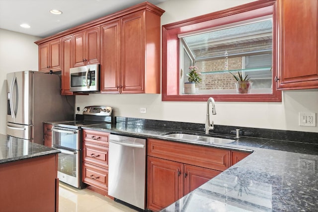 7050 26th Pkwy, Berwyn, IL 60402 - kitchen featuring appliances with stainless steel finishes, a sink, dark stone countertops, recessed lighting, and brown cabinets