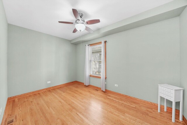 7050 26th Pkwy, Berwyn, IL 60402 - empty room featuring a ceiling fan and light wood-type flooring