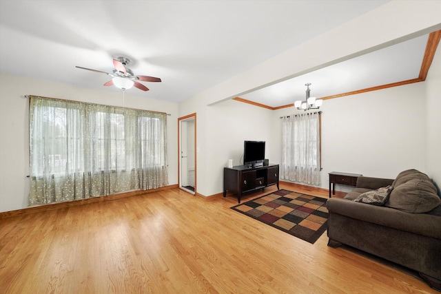 7050 26th Pkwy, Berwyn, IL 60402 - living area featuring a chandelier, healthy amount of natural light, a ceiling fan, and wood finished floors