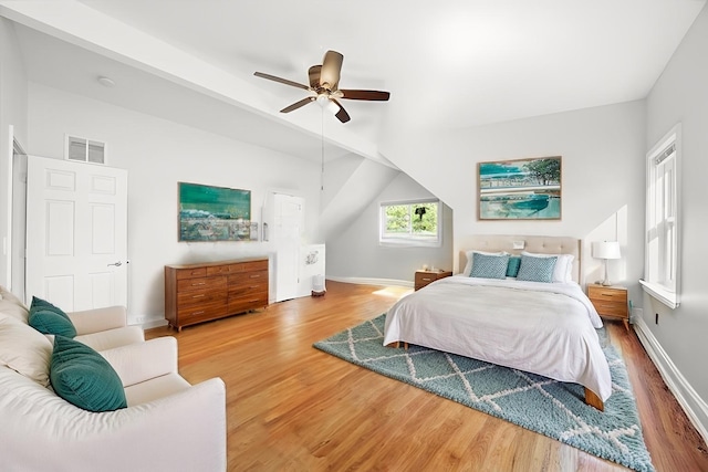 7050 26th Pkwy, Berwyn, IL 60402 - bedroom featuring wood finished floors, vaulted ceiling, baseboards, and a ceiling fan