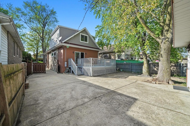 7050 26th Pkwy, Berwyn, IL 60402 - view of home's exterior featuring a wooden deck, a patio area, and a fenced backyard