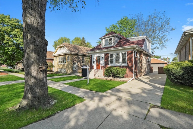 7050 26th Pkwy, Berwyn, IL 60402 - bungalow-style home with brick siding, a front lawn, an outbuilding, and a detached garage