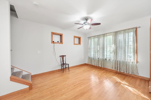 7050 26th Pkwy, Berwyn, IL 60402 - unfurnished room featuring a ceiling fan, wood finished floors, baseboards, and stairway