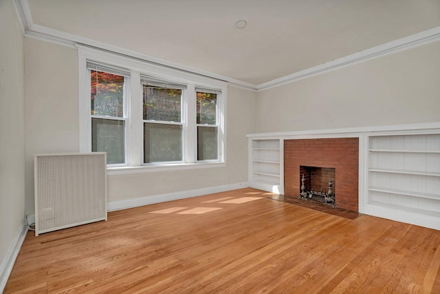 2749 N Hampden Ct Unit 1E, Chicago, IL 60614 - unfurnished living room with baseboards, ornamental molding, wood finished floors, built in shelves, and a brick fireplace