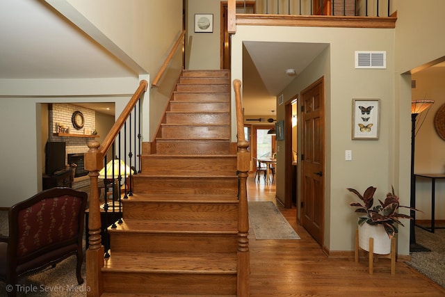 14822 S Eagle Ridge Dr, Homer Glen, IL 60491 - stairway featuring wood finished floors and a brick fireplace