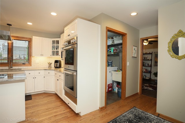 14822 S Eagle Ridge Dr, Homer Glen, IL 60491 - kitchen with stainless steel double oven, a sink, light wood-style floors, white cabinetry, and recessed lighting