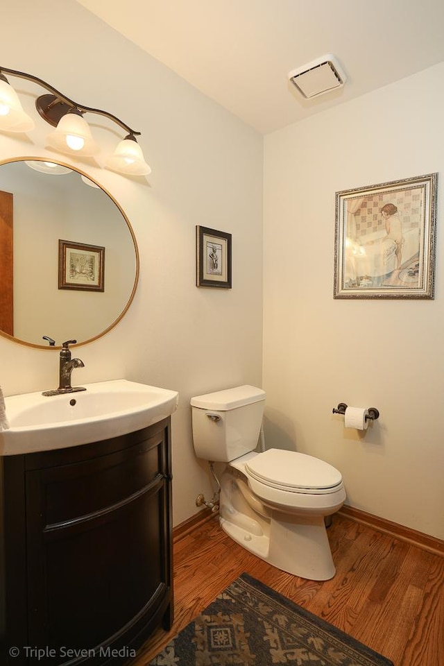 14822 S Eagle Ridge Dr, Homer Glen, IL 60491 - bathroom with toilet, wood finished floors, vanity, and baseboards