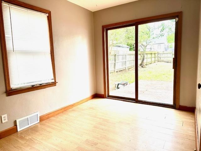 913 Academy St, Dixon, IL 61021 - spare room with wood finished floors and baseboards