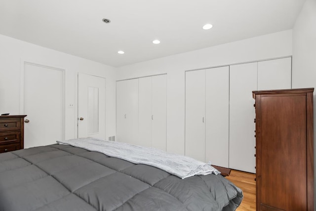 1203 Central St Unit C, Evanston, IL 60201 - bedroom with two closets, light wood-style flooring, and recessed lighting