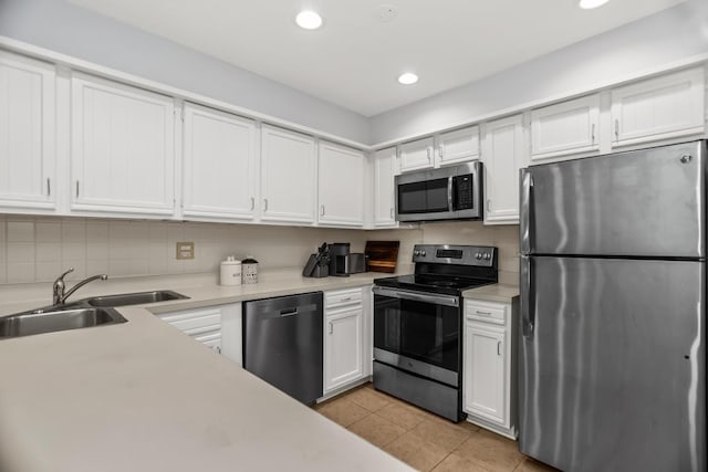 1203 Central St Unit C, Evanston, IL 60201 - kitchen featuring appliances with stainless steel finishes, a sink, light countertops, light tile patterned floors, and white cabinetry