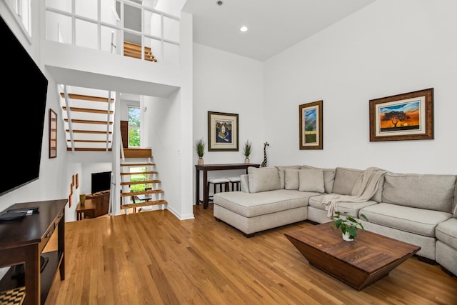 1203 Central St Unit C, Evanston, IL 60201 - living room with wood finished floors, stairs, recessed lighting, a towering ceiling, and baseboards