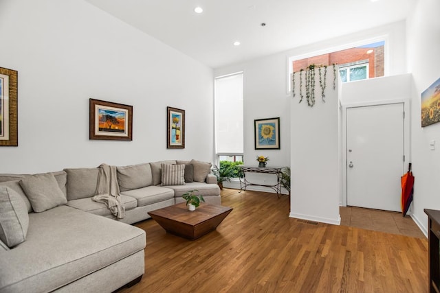 1203 Central St Unit C, Evanston, IL 60201 - living room with recessed lighting, light wood-style flooring, a high ceiling, and baseboards