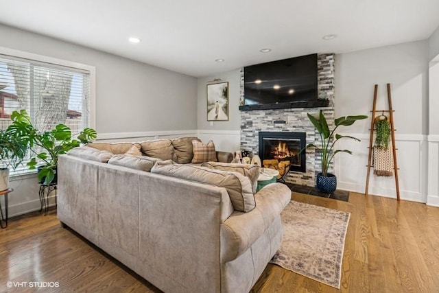 7146 S Oketo Ave, Bridgeview, IL 60455 - living area with a large fireplace, wood finished floors, and a wainscoted wall