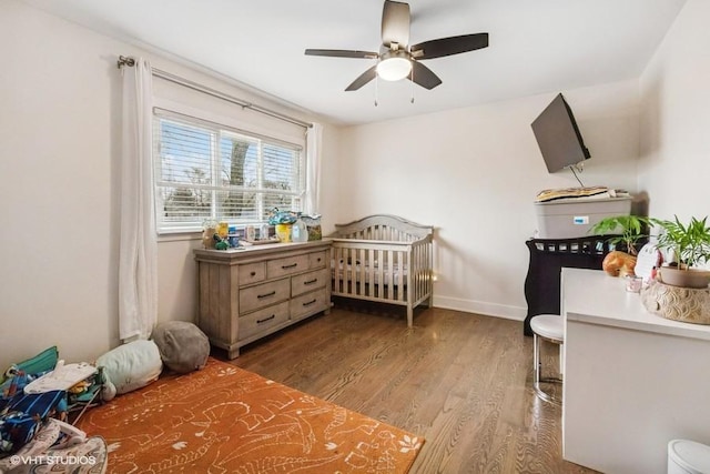 7146 S Oketo Ave, Bridgeview, IL 60455 - bedroom with wood finished floors, baseboards, a crib, and a ceiling fan