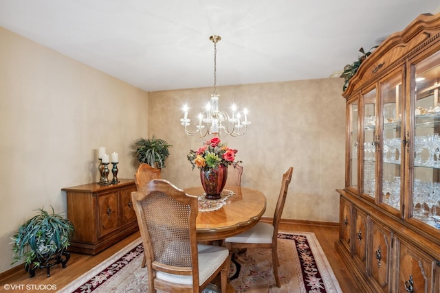 8806 175th St, Tinley Park, IL 60487 - dining area featuring a chandelier, light wood-style floors, and baseboards