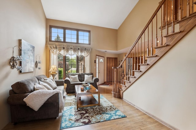 8806 175th St, Tinley Park, IL 60487 - living area with stairs, light wood-style flooring, and a towering ceiling