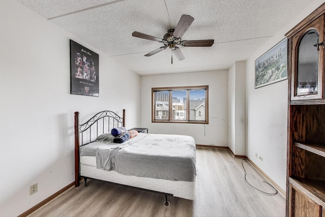 1433 Perry St Unit 305, Des Plaines, IL 60016 - bedroom featuring light wood-type flooring, a textured ceiling, baseboards, and ceiling fan