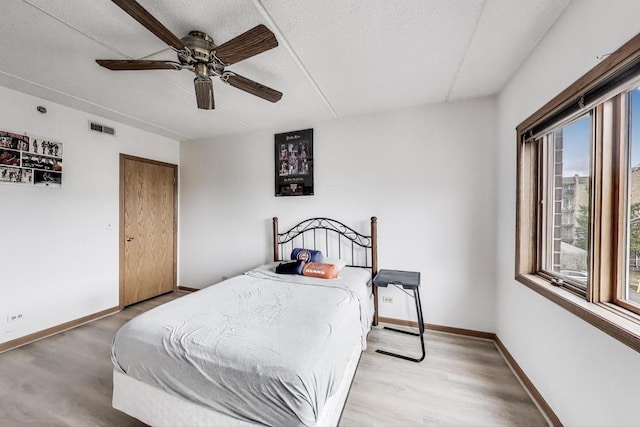 1433 Perry St Unit 305, Des Plaines, IL 60016 - bedroom with multiple windows, baseboards, a textured ceiling, and ceiling fan