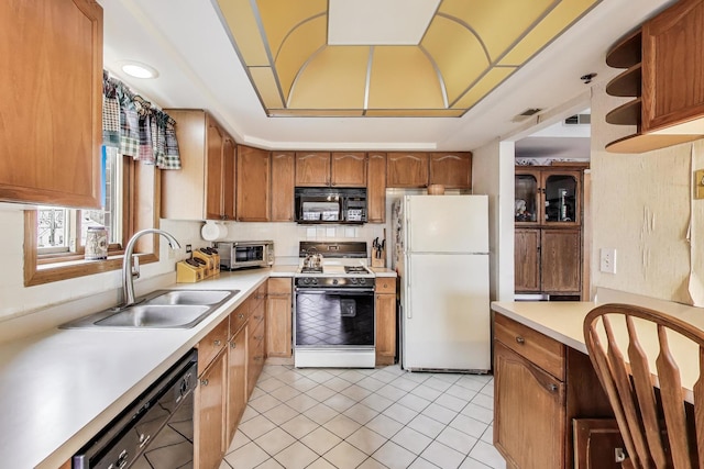 1433 Perry St Unit 305, Des Plaines, IL 60016 - kitchen featuring black appliances, a sink, light countertops, light tile patterned flooring, and brown cabinets