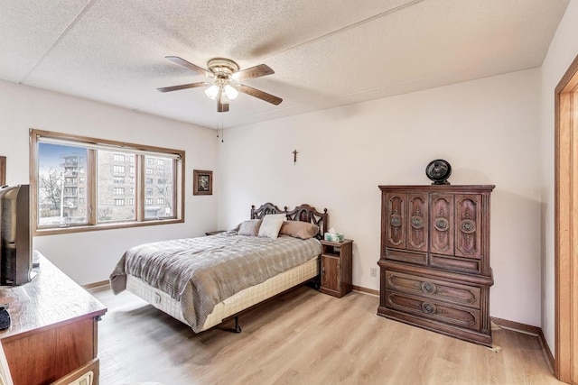 1433 Perry St Unit 305, Des Plaines, IL 60016 - bedroom with baseboards, light wood finished floors, and a textured ceiling