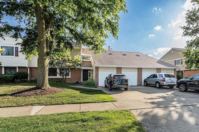 143 W Fabish Dr Unit 143, Buffalo Grove, IL 60089 - view of property featuring brick siding, driveway, a front lawn, and a garage