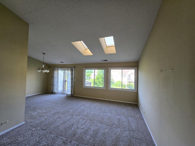 143 W Fabish Dr Unit 143, Buffalo Grove, IL 60089 - carpeted spare room featuring a chandelier, a textured ceiling, a skylight, and vaulted ceiling