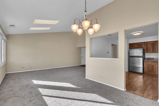 143 W Fabish Dr Unit 143, Buffalo Grove, IL 60089 - empty room featuring a skylight, dark colored carpet, a chandelier, and high vaulted ceiling