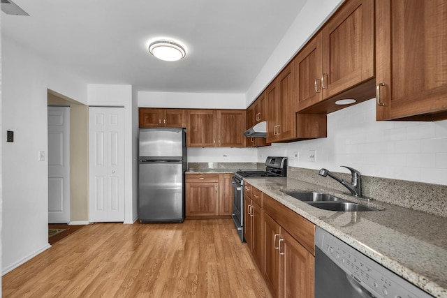 143 W Fabish Dr Unit 143, Buffalo Grove, IL 60089 - kitchen with stainless steel appliances, under cabinet range hood, light wood-style flooring, and light stone counters