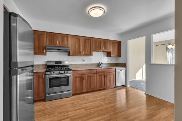 143 W Fabish Dr Unit 143, Buffalo Grove, IL 60089 - kitchen with stainless steel appliances, under cabinet range hood, and brown cabinetry