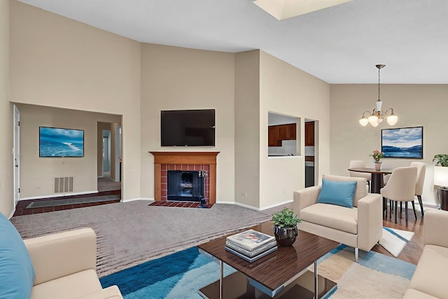 143 W Fabish Dr Unit 143, Buffalo Grove, IL 60089 - living area with a chandelier, a tiled fireplace, and high vaulted ceiling