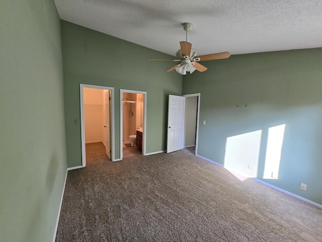 143 W Fabish Dr Unit 143, Buffalo Grove, IL 60089 - unfurnished bedroom with dark colored carpet, a walk in closet, a textured ceiling, high vaulted ceiling, and a ceiling fan