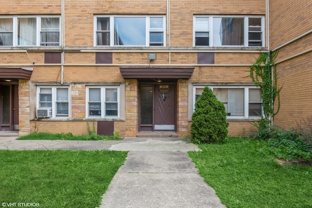 6819 N Seeley Ave Unit 2A, Chicago, IL 60645 - entrance to property with brick siding, cooling unit, and a lawn