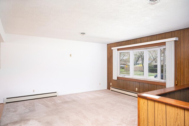 207 Muehl Dr, Lockport, IL 60441 - unfurnished room featuring a baseboard radiator, light colored carpet, wood walls, a textured ceiling, and a dry bar