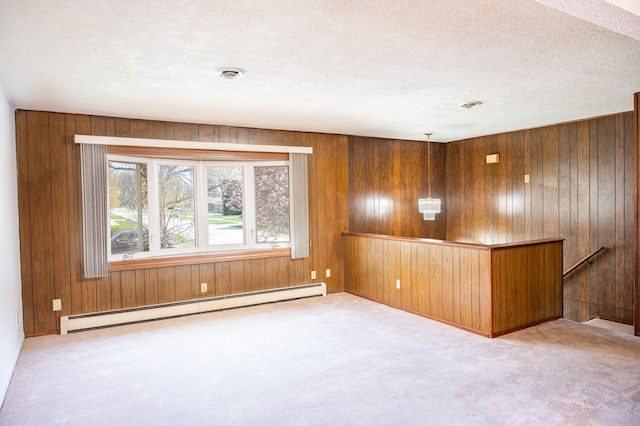 207 Muehl Dr, Lockport, IL 60441 - carpeted empty room with a baseboard radiator, wood walls, and a textured ceiling