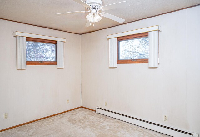 207 Muehl Dr, Lockport, IL 60441 - spare room featuring a baseboard heating unit, plenty of natural light, a textured ceiling, carpet floors, and ceiling fan