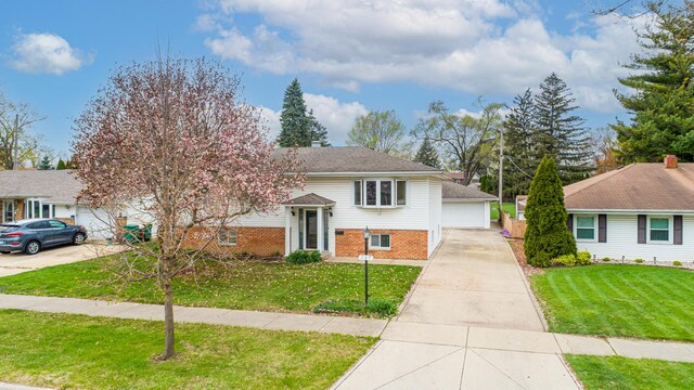 207 Muehl Dr, Lockport, IL 60441 - view of front of property featuring brick siding, a front lawn, and a garage