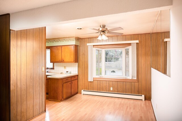 207 Muehl Dr, Lockport, IL 60441 - kitchen with brown cabinetry, a baseboard radiator, light wood finished floors, a ceiling fan, and light countertops