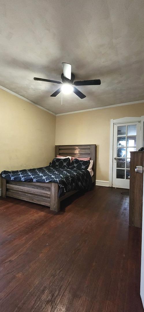 1605 S 16th Ave, Maywood, IL 60153 - bedroom featuring wood finished floors, ornamental molding, a ceiling fan, and baseboards