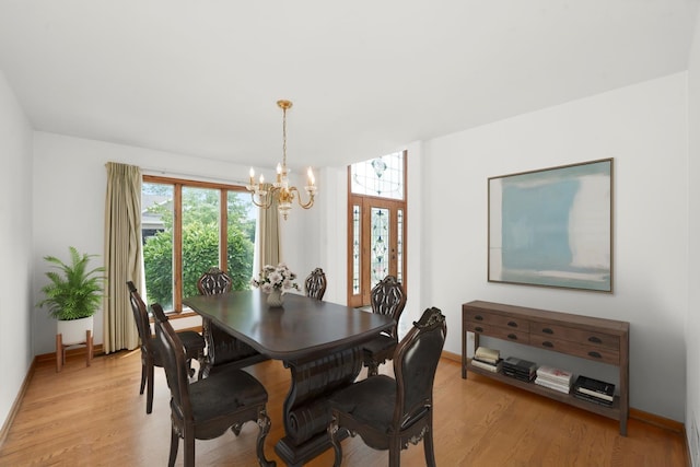 dining room with a chandelier and light wood-type flooring