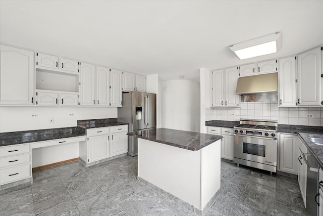 kitchen with appliances with stainless steel finishes, under cabinet range hood, white cabinets, and tasteful backsplash
